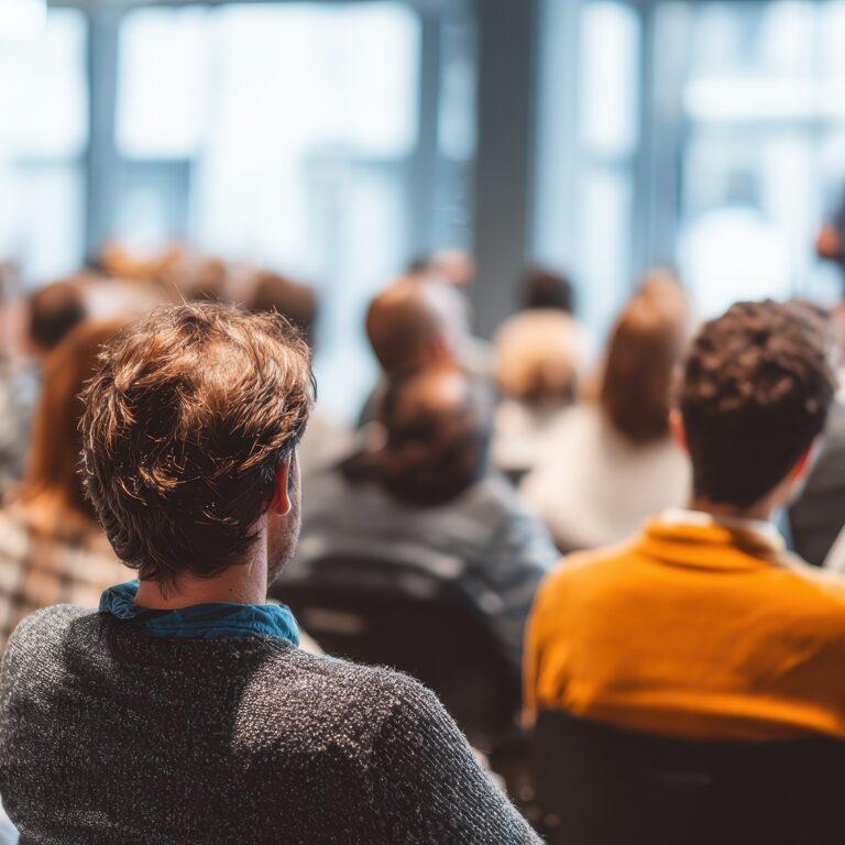 instructor led employee training session for office workers featuring expert speakers at a community summit focused on conference planning and business learning